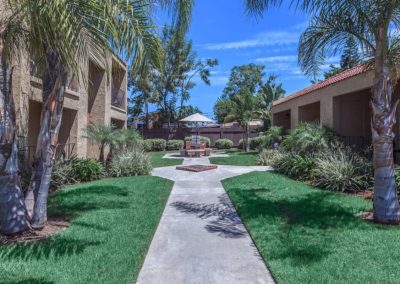 pathway through evergreen villas with grass