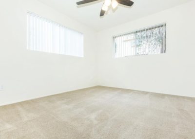 bedroom with windows and ceiling fan at mollison terrace