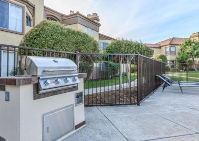 barbeque and lounge chairs at arezzo apartments