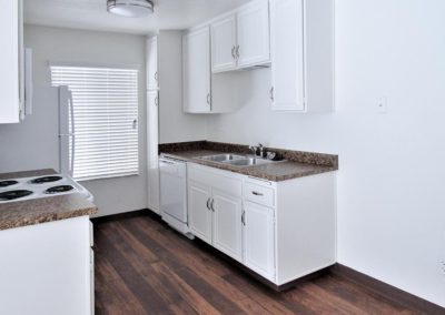 kitchen area with stove refrigerator and sink at arizona towers