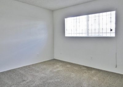 bedroom with carpet and window at arizona towers