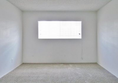 bedroom with carpet and window at arizona towers