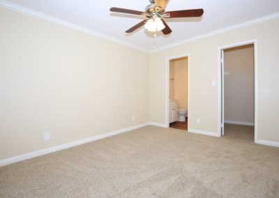 bedroom with bathroom and closet at city gardens