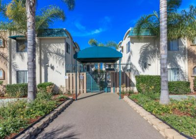 gated front entrance and landscape to city gardens