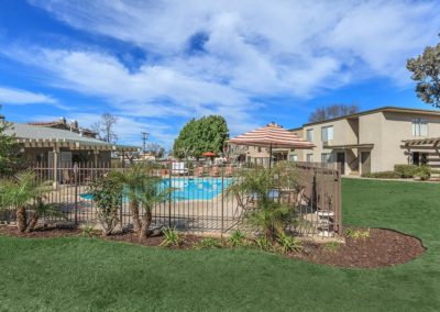 grass area and gated pool at the courtyards