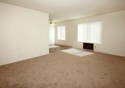 carpeted living area with air conditioner at the courtyards