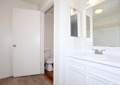 emerald vista bathroom with toilet, sink and mirror