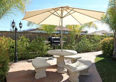 outdoor patio with table and barbeque