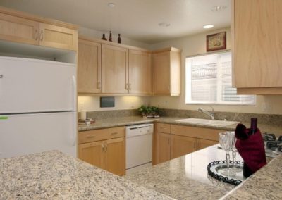 kitchen area with refrigerator and sink