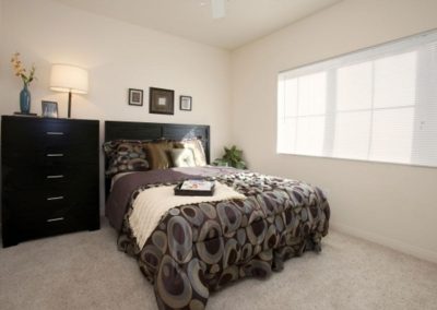 bedroom with dresser and lamp