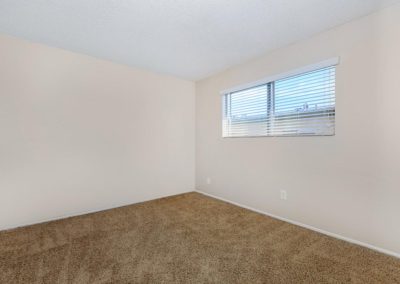 carpeted bedroom with window at la mesa palms