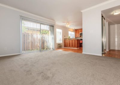 overview of living area with sliding glass door at la mesa spring gardens