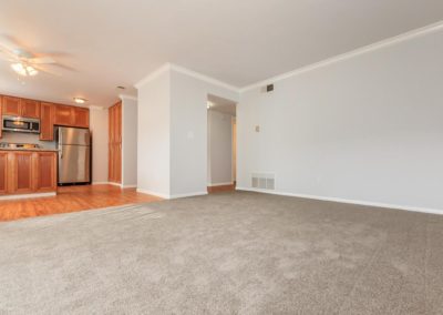 carpeted living area with kitchen at la mesa spring gardens