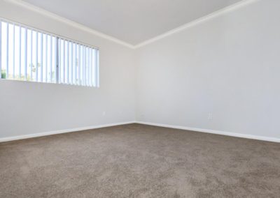 carpeted bedroom with window at la mesa spring gardens