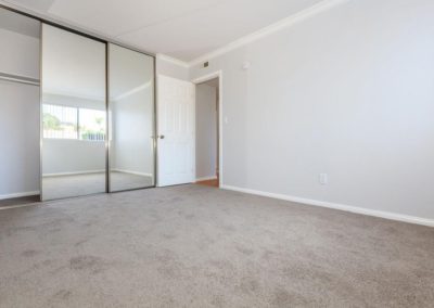 carpeted bedroom with closet at la mesa spring gardens