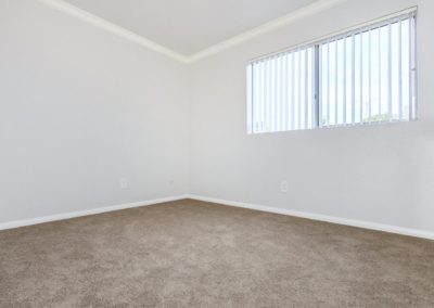 carpeted bedroom with window at la mesa spring gardens