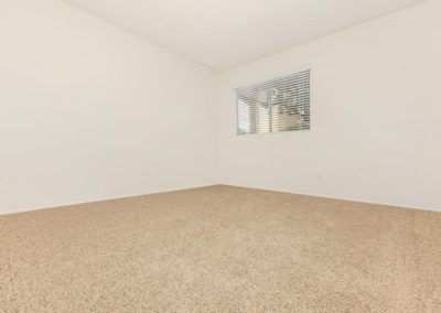 carpeted bedroom at la mesa spring gardens with window