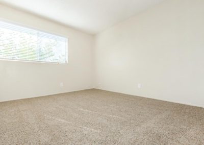 carpeted bedroom with window at la mesa spring gardens