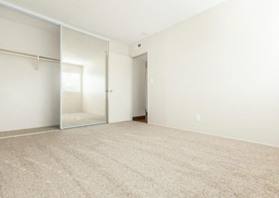 carpeted bedroom with closet at la mesa spring gardens