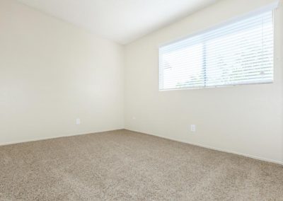 carpeted bedroom with window at la mesa spring gardens