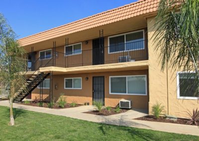 exterior and pathway with grass at maple view apartments