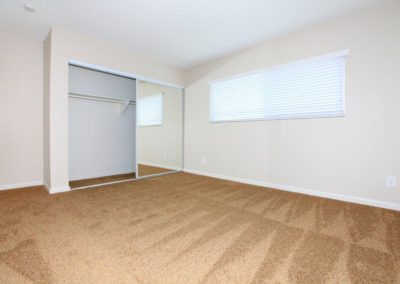 carpeted bedroom and closet at maple view