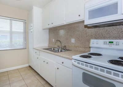 kitchen with sink and stove at fresno terrace