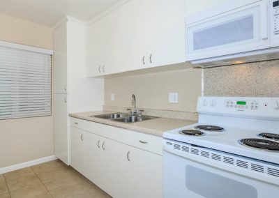 kitchen with microwave sink and stove at fresno terrace