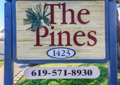 front sign at the pines apartments