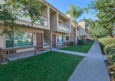 exterior walkway with grass at parklane apartments