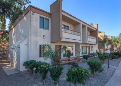 exterior of parklane apartments with landscape