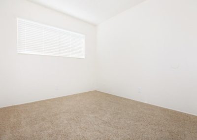 carpeted bedroom at windsong villas